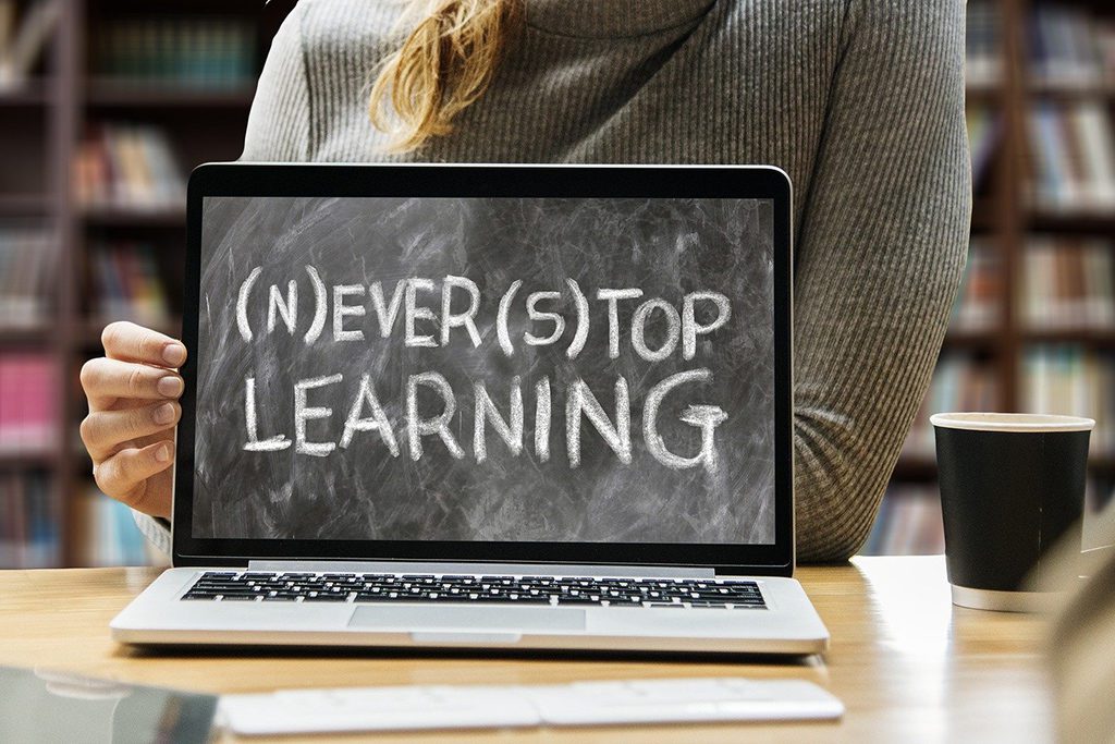 Woman behind a laptop promoting learning online