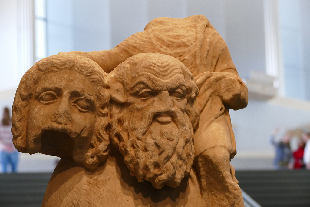 A statue of the mythical Satyr Silenus from the the 2nd century BC. The wise teacher is carrying on his shoulder the wine god Dionysos holding a theatrical mask.