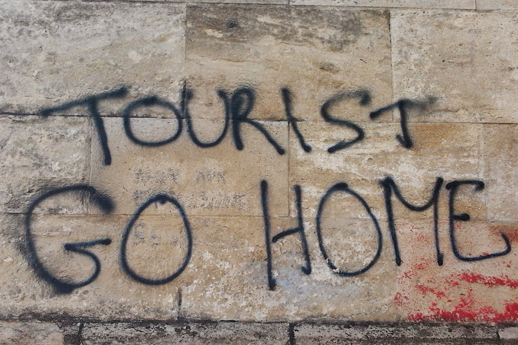 Graffiti from Bordeaux saying Tourist Go Home