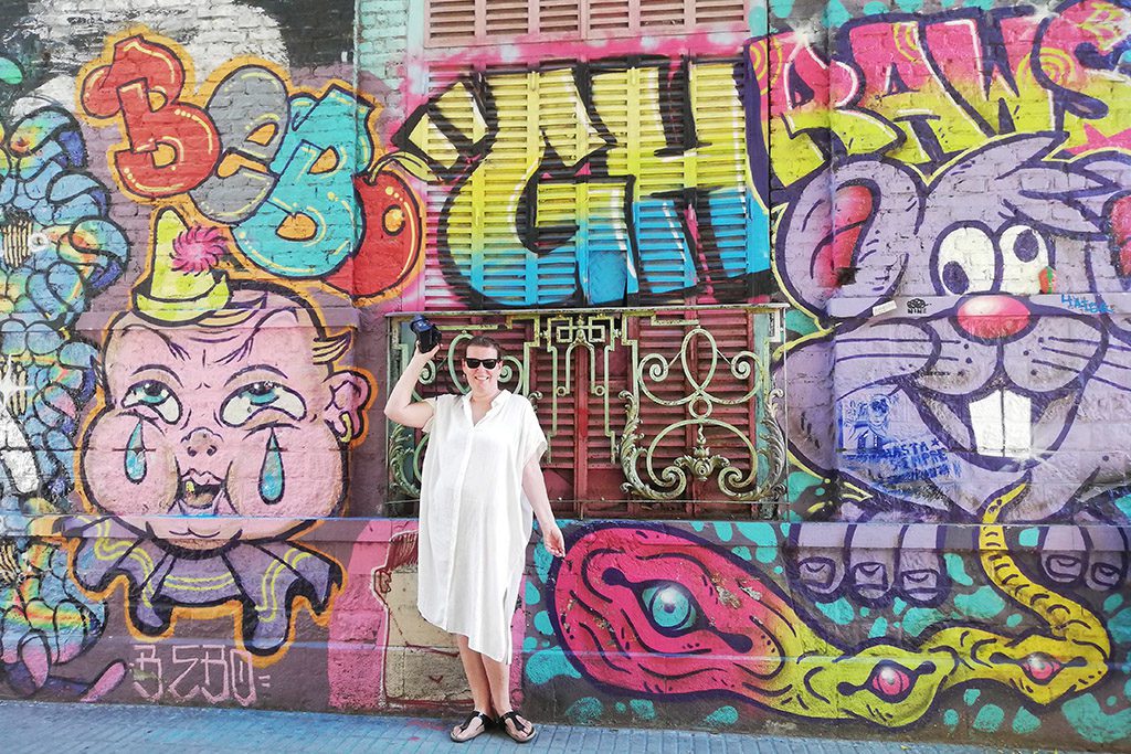 Renata Green in front of a Grafitti in the district of Palermo in Buenos Aires