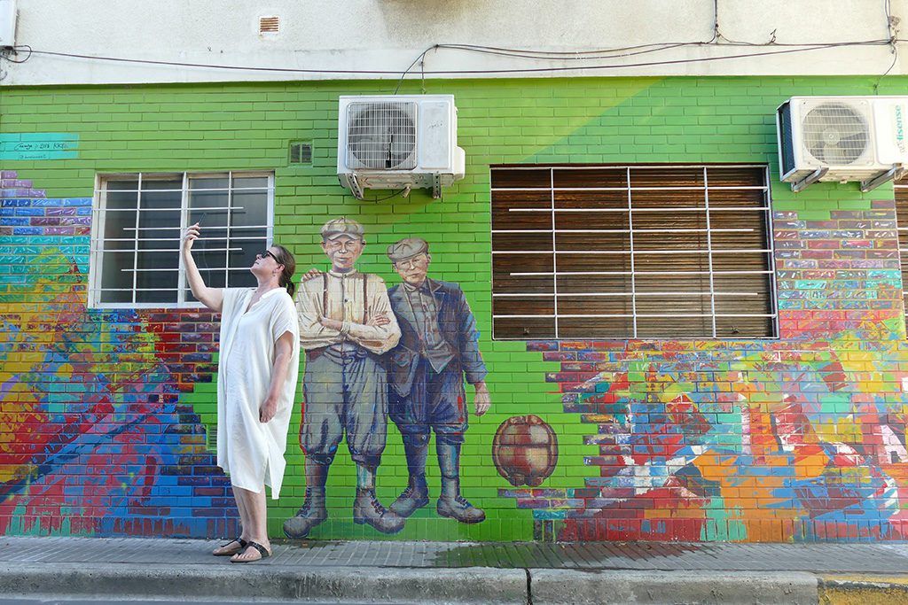 During solo travel taking pictures of selfies in front of a mural at the district of Palermo in Buenos Aires.