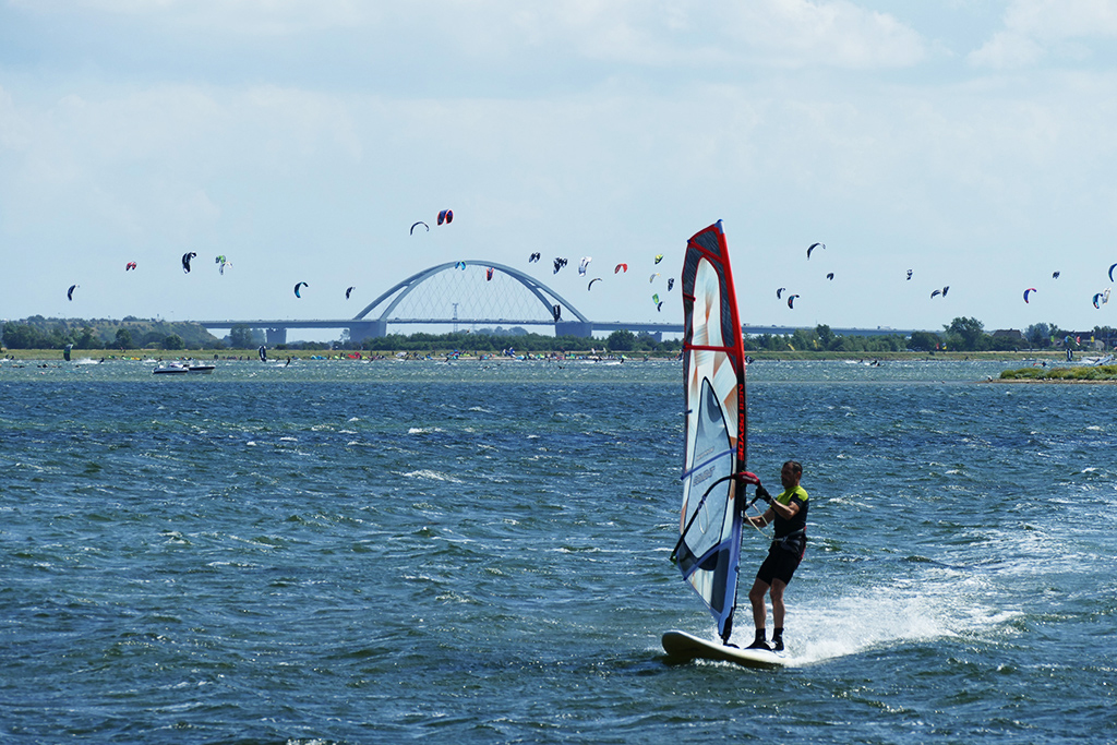 Surfer in front of the Fehmarnsoundbridge off the Island of Fehmarn