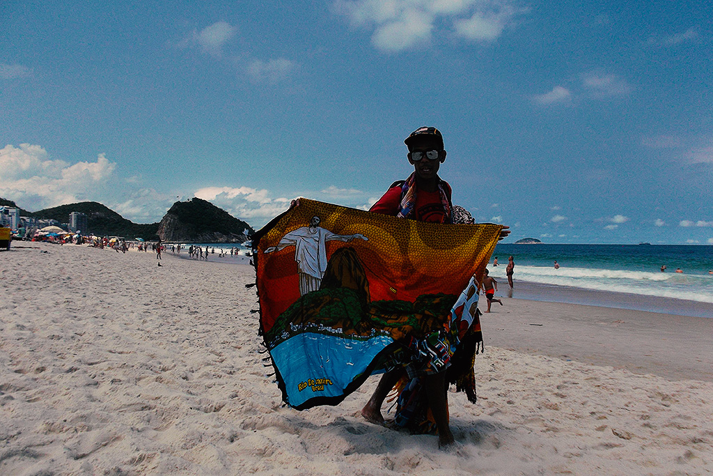 Man selling Cangas on the Copacabana Beach in Rio de Janeiro in Brazil.