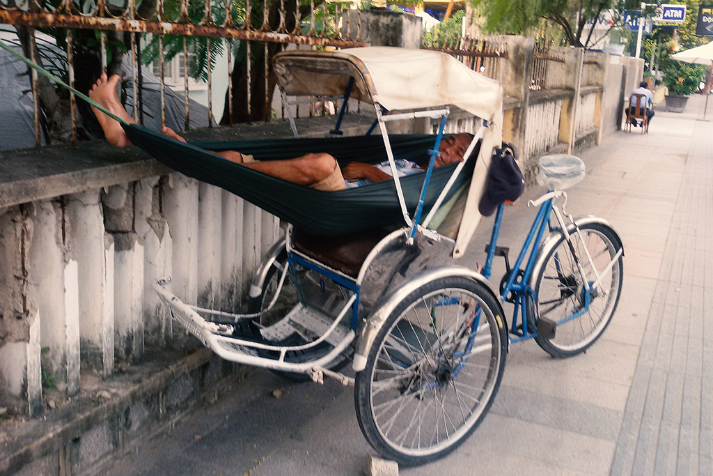 Man sleeping in a rikshaw in Nha Trang