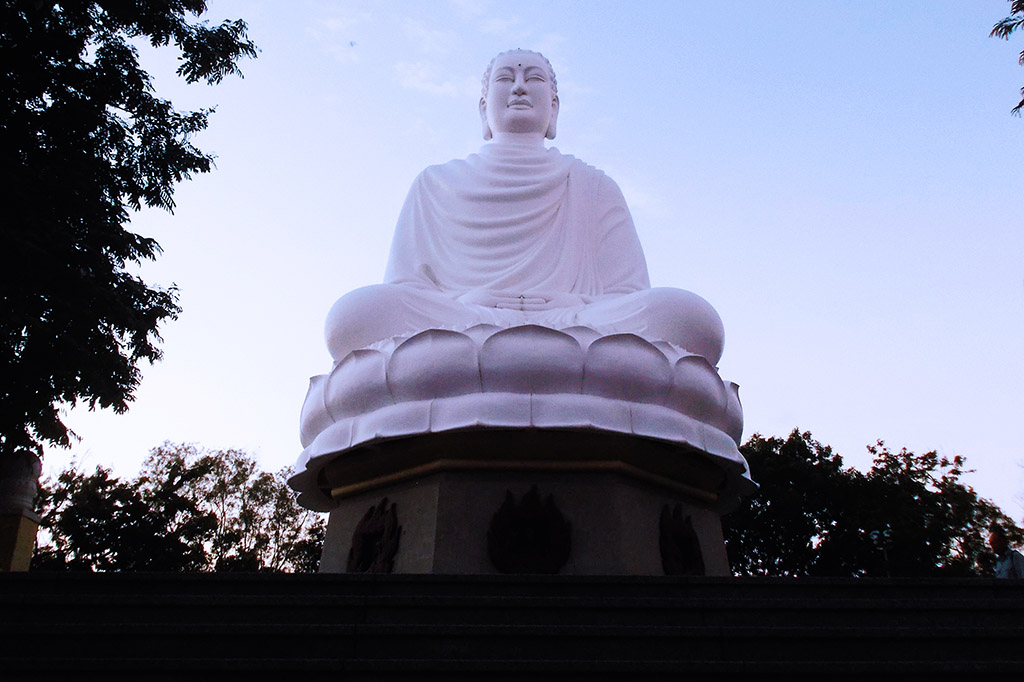 White concrete statue of Gautama Buddha at the Long Son Pagoda at the beach resort Nha Trang