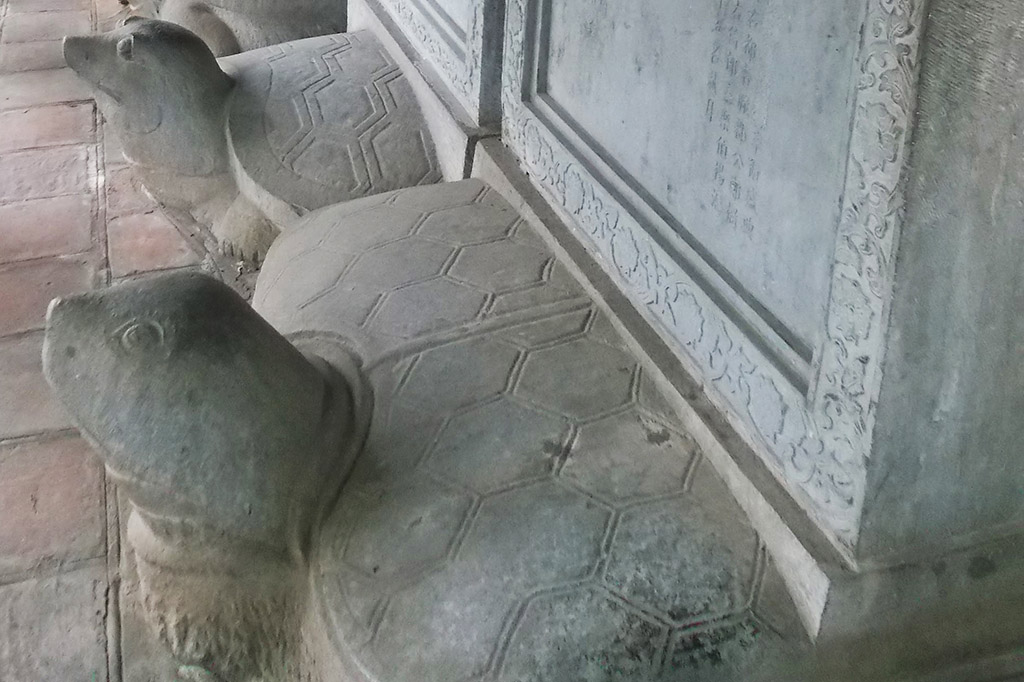 Turtles carrying steles at the Temple of Literature in Hanoi, gateway to the mysterious HALONG BAY