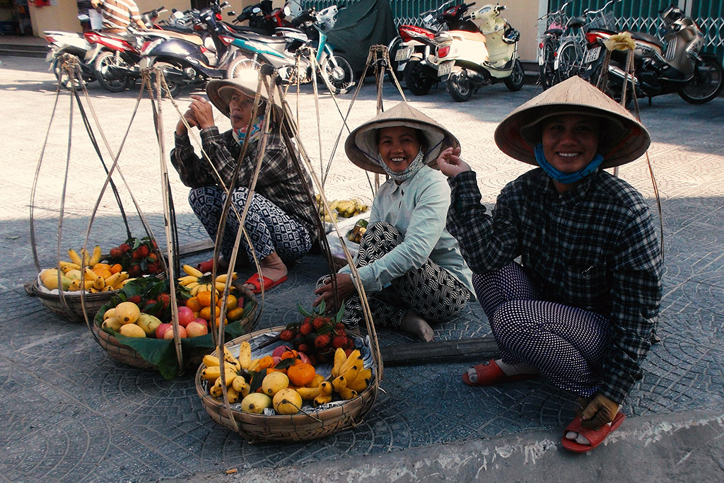 Three street vendors in Hoi An