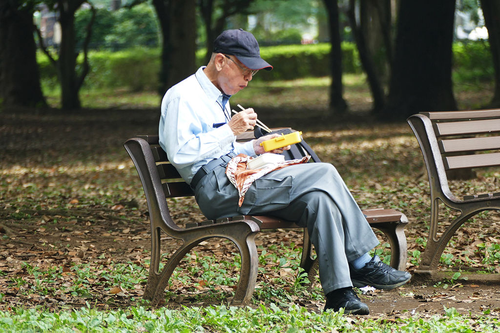 Man eating at Yoyogi Park at Tokyo in Japan