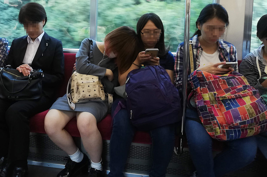 Ladies sleeping on the train in Tokyo Japan