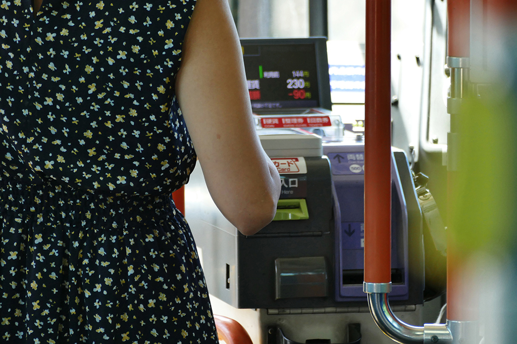 Lady paying fare at bus in 4 Days Kyoto Treasure Box of Japan
