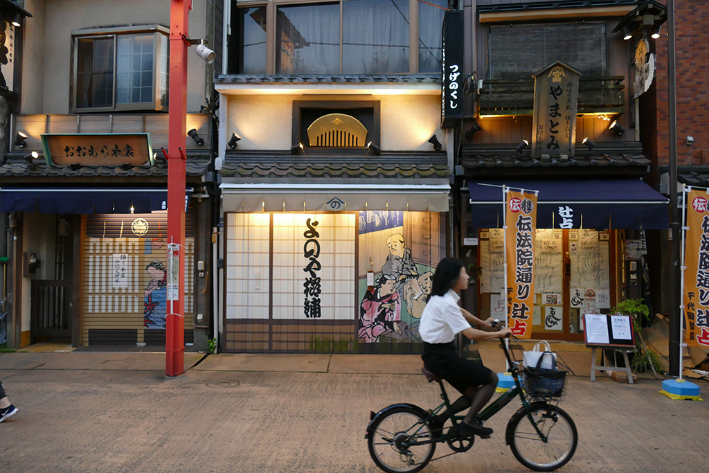 Woman cycling at the Asakusa neighborhood in Tokyo