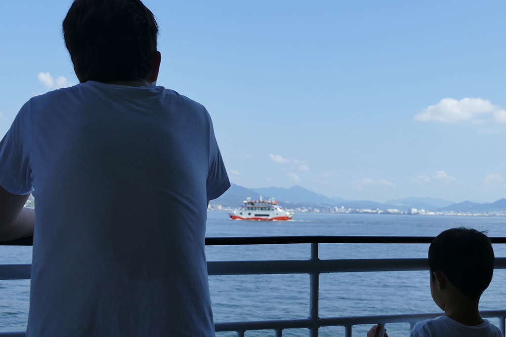 Man and boy on the ferry to Miyajima Island