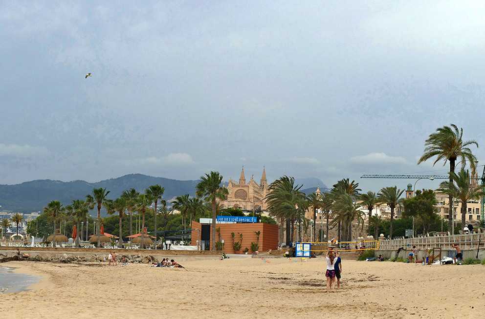 Beach at Palma de Mallorca with a view of the city.