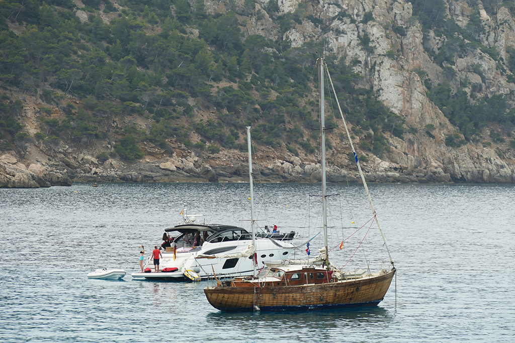 All kinds of vessels are bobbing off Sant Elm's shore.