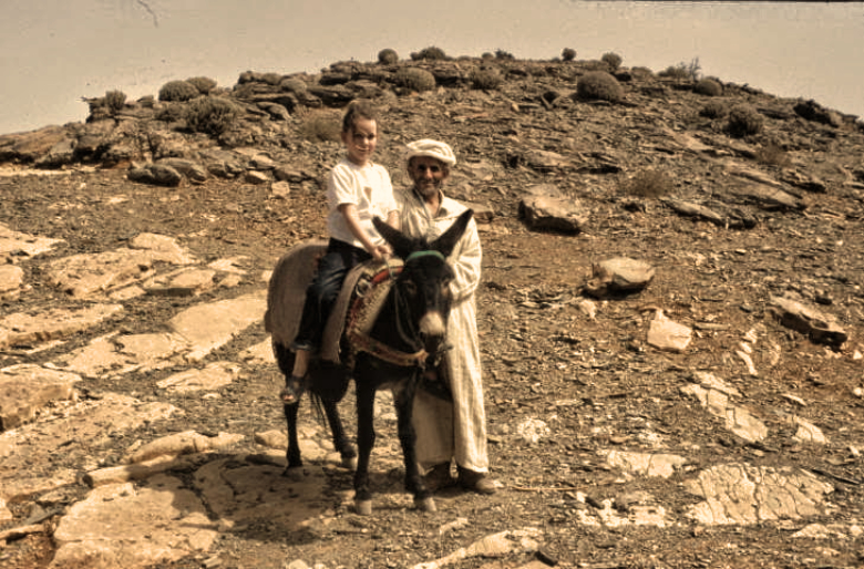 Solo Travel With Kids to Central America: Girl on the back of a donkey in Morocco