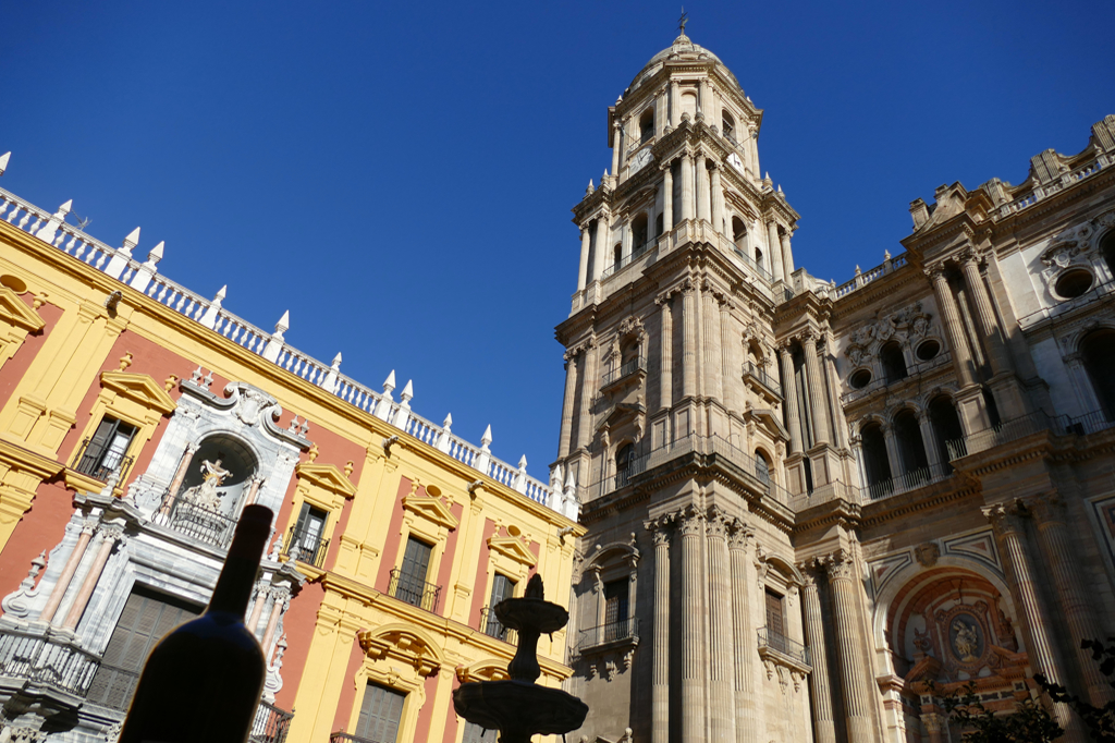 Centro Cultural Fundación Unicaja housed in the colorful Baroque building and the Cathedral's one tower.