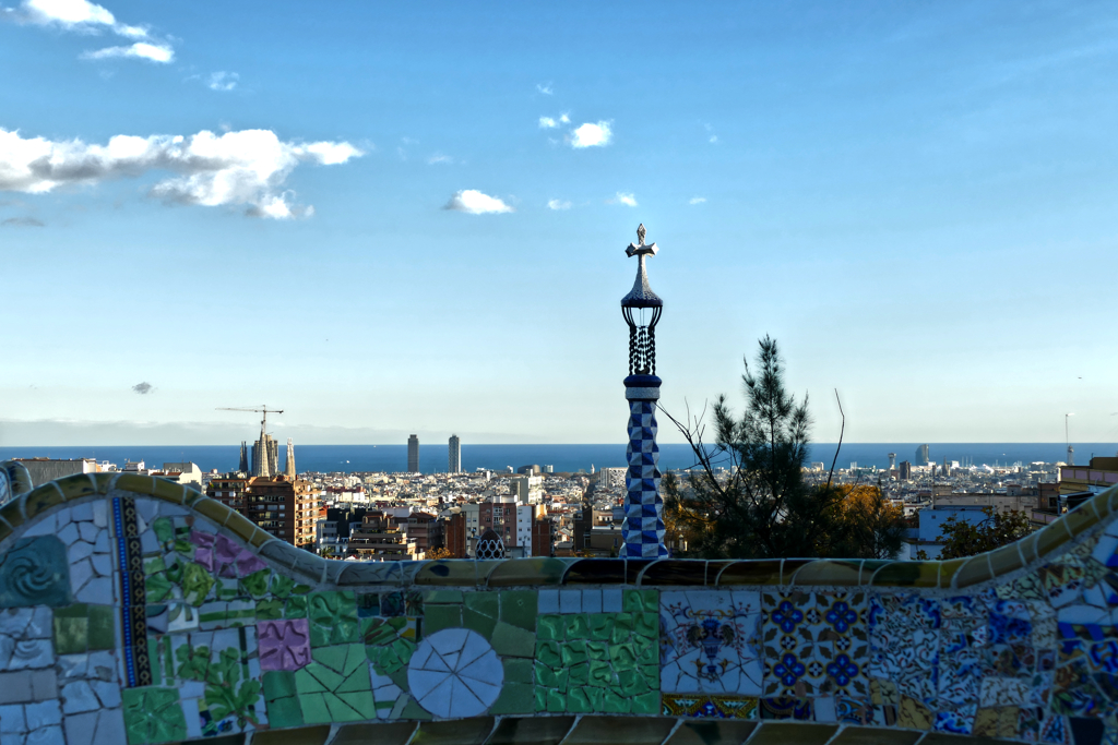 Iconic view of Barcelona from the famous ceramic benches of the Parque Güell. Gaudi Barcelona Guide Modernism