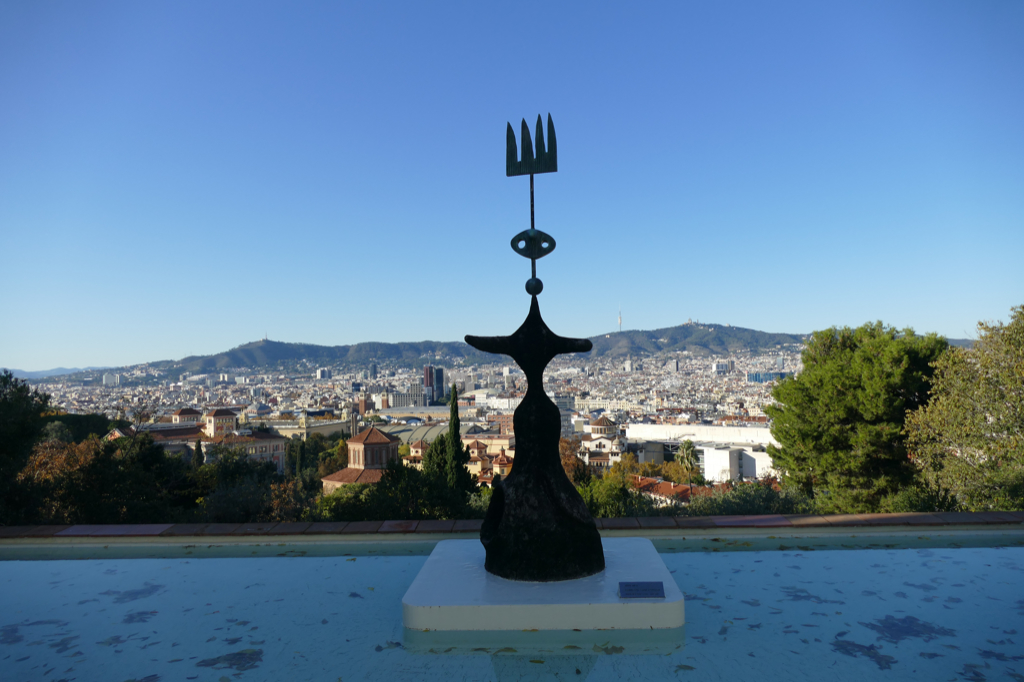 Estudio para un monumento ofrecido a la ciudad de Barcelona - Luna, sol y una estrella, in English Study for a monument offered to the city of Barcelona - Moon, sun, and a star with the panoramic view of Barcelona in the backdrop.