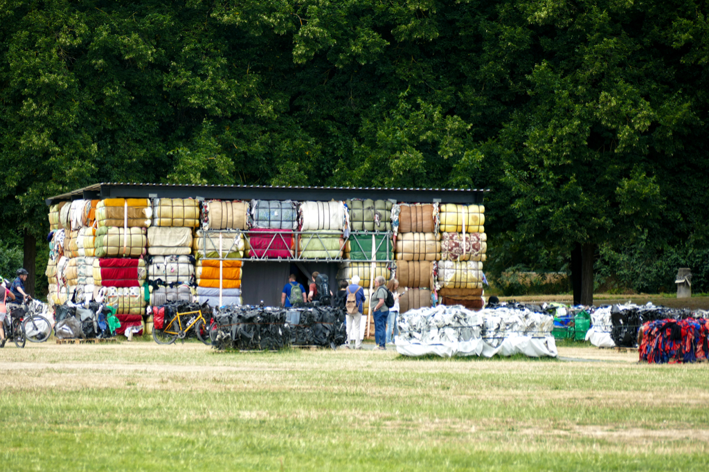 The Nest Collective’s installation Return To Sender consists of textile and electronic waste that industrialized countries simply dump in African lands.