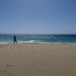 Woman walking on the beach of Morro Jable on Fuerteventura