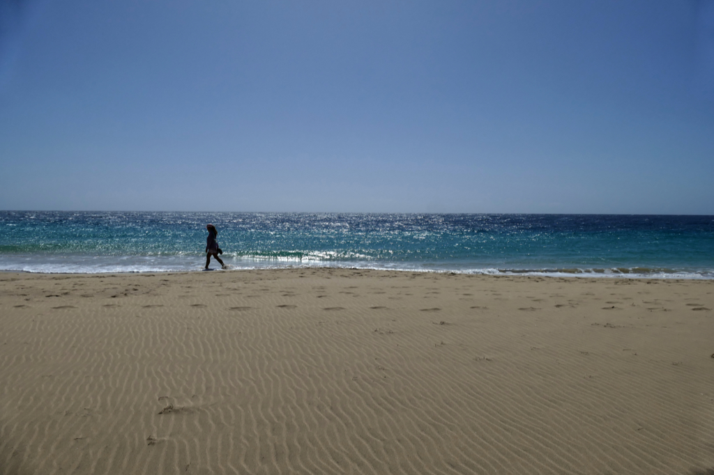 Woman walking on the beach of Morro Jable on Fuerteventura