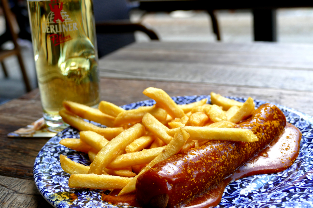 Currywurst, a staple of Berlin,  introduced in a Guide to the Wild East of Berlin