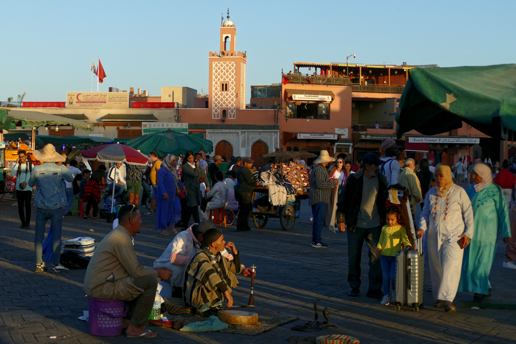 Jemaa Al Fnaa with the beautiful minaret of the Assaha Mosque in the backdrop.
