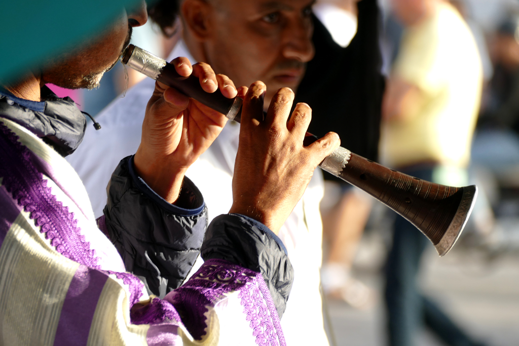 A snake charmer playing his flute.