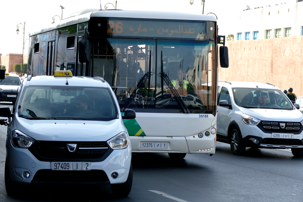 A cab and a bus in the streets of Rabat