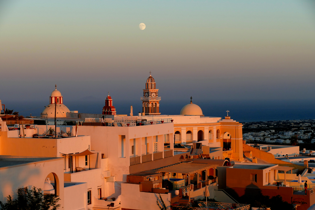 The Catholic Monastery of Dominican Sisters, the tower of the Cathedral of Saint John the Baptist, and the dome of Catholic Church of Saint Stylianos in Fira in Santorini.