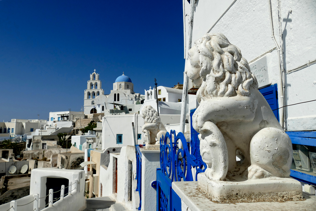 Venetian Lions in Pyrgos in Santorini with the Agia Theodosia church in the background.