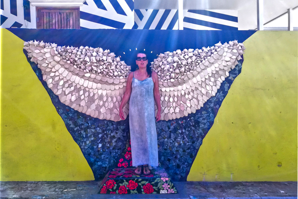 Renata Green in front of a mosaic by Omaira Silva