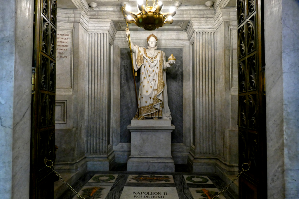 Statue of Napoleon I in his coronation attire by Pierre-Charles Simart watching over the tomb of his son, Napoleon II. In contrast to his father, Napoleon II was the Emperor of France only for a few weeks in 1815.