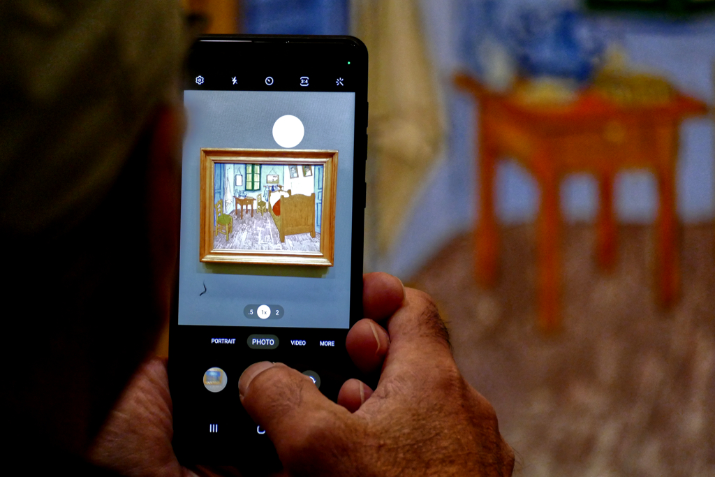 Mobile phone with the painting of Van Gogh's Bedroom in Arles. Paris Museum Pass Skip Lines