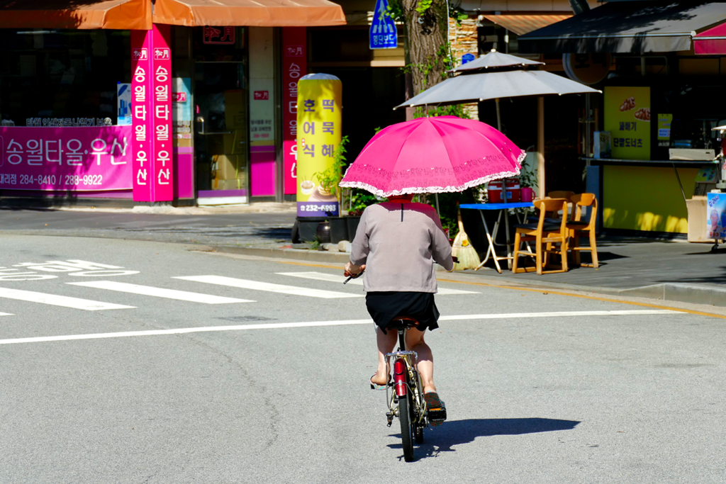Lady riding a bike in the city of Jeonju in Korea.