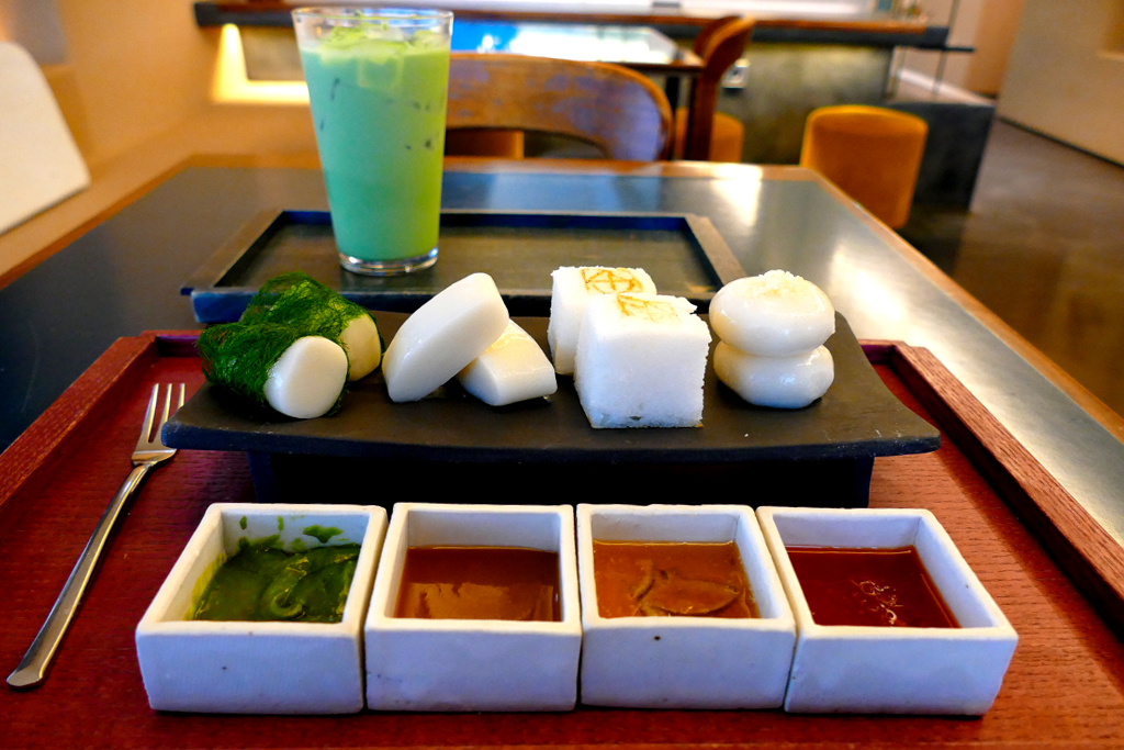 Various small rice cakes with different sauces - from left to right sweet tea cream, sesame spread, zingy lemon and spicy chili dip.
