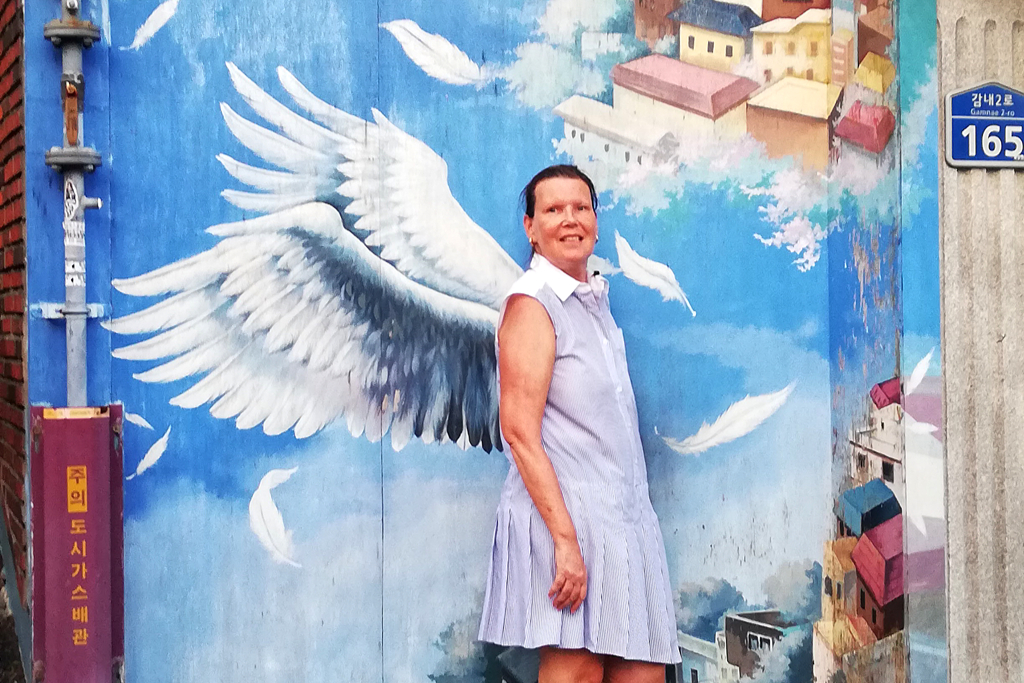 Renata Green in front of a mural at the Gamcheon Culture Village in Busan.
