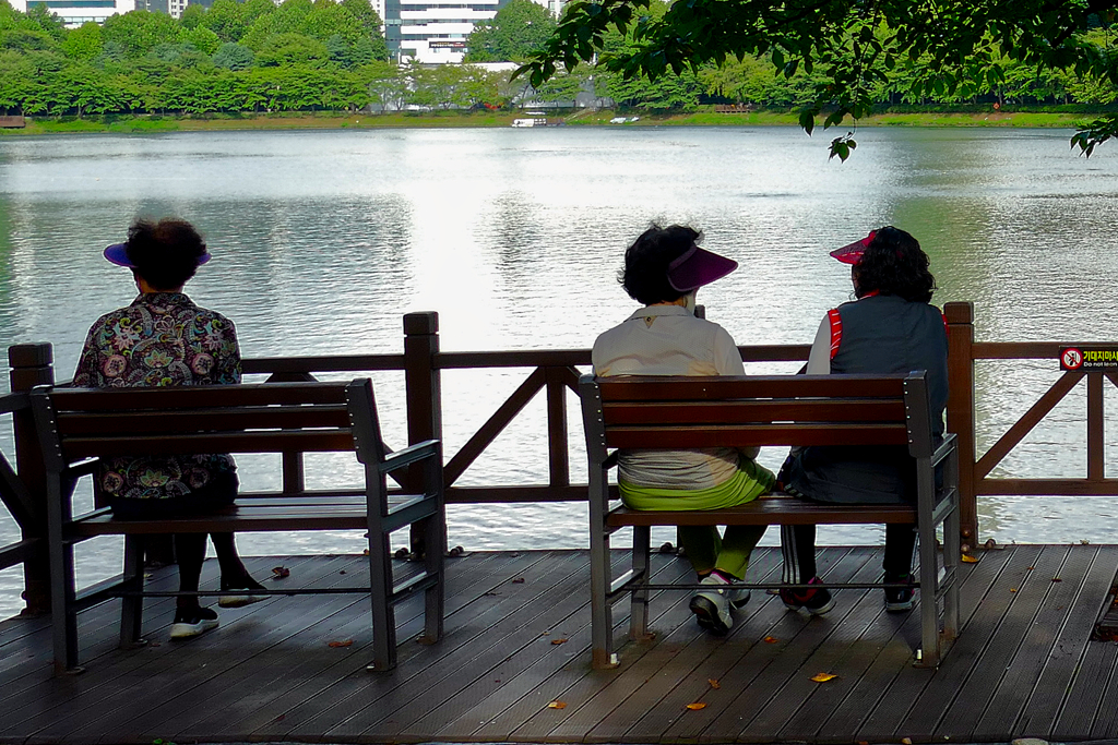 Women sitting on benches in Korea.