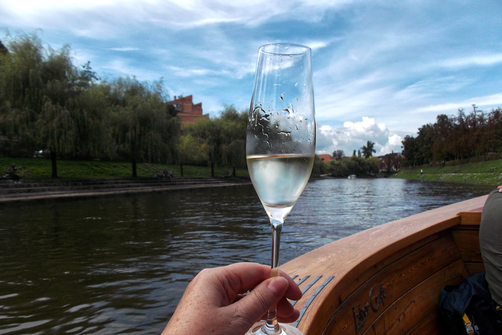 Glass of sparkling wine enjoyed during a cruise on the Ljubljanica river.