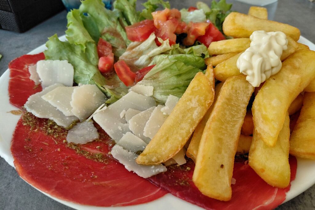 Beef carpaccio with fries in Avignon. 