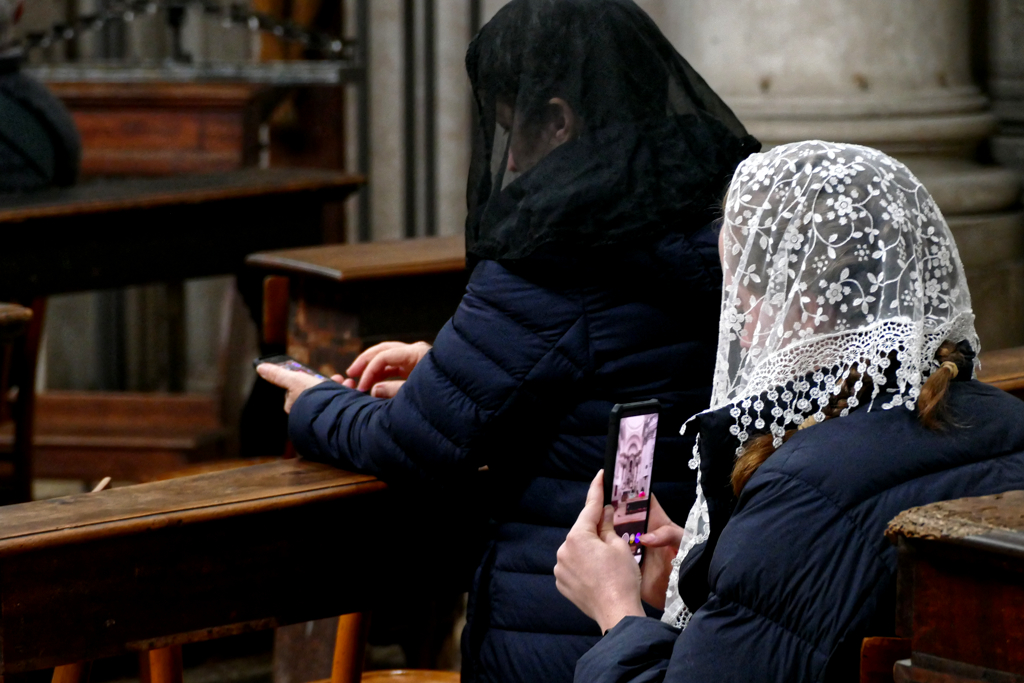 Ladies looking at their phones at a church