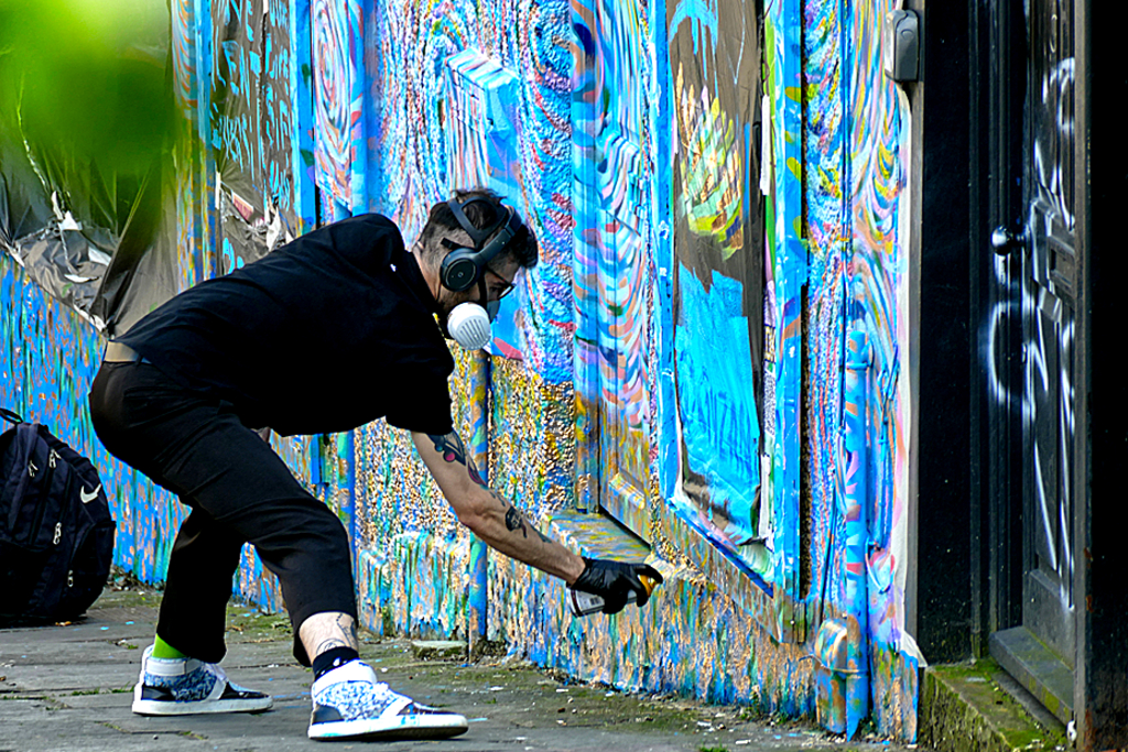 Graffiti sprayer on the job in Stokes Croft.