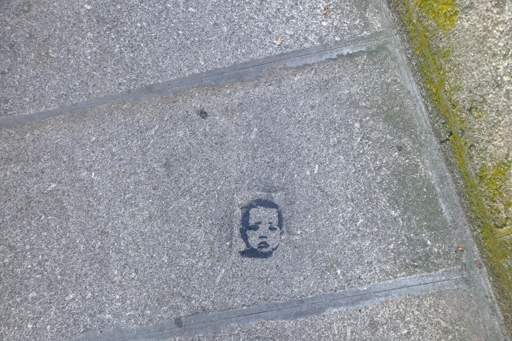 Small piece of street art on the ground in Porto.