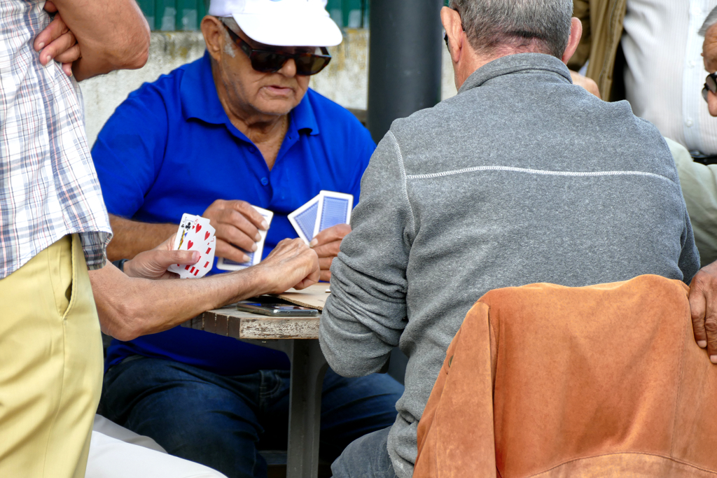 Men playing cards on the streets of Graca.