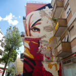 Mural by VHILS and Shepard Fairey in the Graca district of Lisbon.