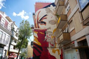 Mural by VHILS and Shepard Fairey in the Graca district of Lisbon.