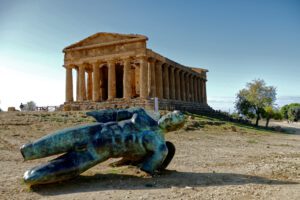 Temple of Concordia in Agrigento with the broken statue of Icarus by Polish artist Igor Mitoraj.