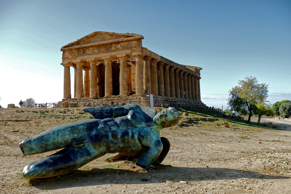 Temple of Concordia in Agrigento with the  broken statue of Icarus by Polish artist Igor Mitoraj seen on a day trip to Temples Agrigento Villa Romana