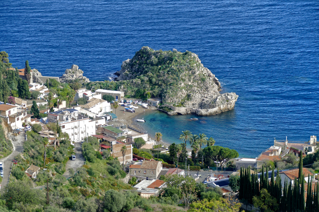 View of Spiaggia di Isola Bella and the Grotta Azzurra on the shore below Taormina.