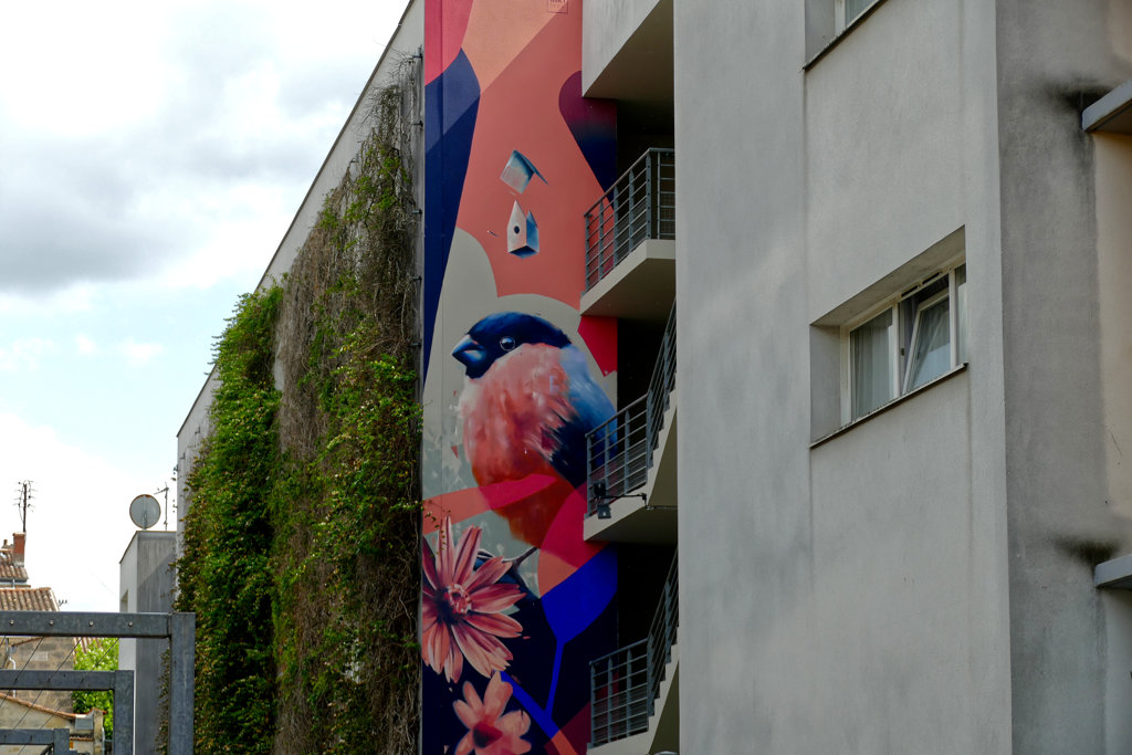 Mural by MIKA as part of the Best Street Art in Bordeaux on the Left Bank of the Garonne. It is called Migration.